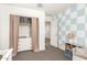 Bedroom with neutral walls, plush carpet, closet storage, a blue accent wall, and a glider chair at 8336 E Idaho Ave, Mesa, AZ 85209