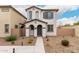 Charming two-story home with stucco exterior, landscaped yard, and inviting front entrance at 8336 E Idaho Ave, Mesa, AZ 85209