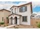 Inviting two-story home with stucco exterior, arched entryway, and well-maintained front yard at 8336 E Idaho Ave, Mesa, AZ 85209