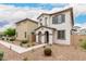 Attractive two-story home with stucco exterior, grey window trim, and low maintenance landscaping at 8336 E Idaho Ave, Mesa, AZ 85209