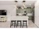 Modern kitchen featuring an island with bar stools and stainless appliances at 8336 E Idaho Ave, Mesa, AZ 85209