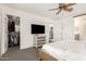 Bright main bedroom featuring a ceiling fan, neutral walls, plush carpet, and a walk-in closet at 8336 E Idaho Ave, Mesa, AZ 85209