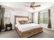 Bright main bedroom featuring a ceiling fan, neutral walls, plush carpet, and ample natural light at 8336 E Idaho Ave, Mesa, AZ 85209