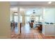 Open-concept living room showcasing natural light, a white brick fireplace, and wood look flooring at 8379 E San Salvador Dr, Scottsdale, AZ 85258