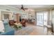 Cozy living room with comfortable seating, ceiling fan, and access to the patio through sliding glass doors at 8379 E San Salvador Dr, Scottsdale, AZ 85258