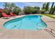 Swimming pool with lounge chairs surrounded by lush greenery in backyard at 8379 E San Salvador Dr, Scottsdale, AZ 85258