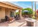 Inviting back patio with comfortable seating areas, colorful decor, fire pit, and beautifully landscaped yard at 9442 N 106Th Pl, Scottsdale, AZ 85258