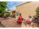 Backyard patio with brick tile, lounge chairs, and an umbrella for relaxation at 9442 N 106Th Pl, Scottsdale, AZ 85258