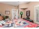 Bright bedroom with a colorful quilt, piano, and various decorative western accents at 9442 N 106Th Pl, Scottsdale, AZ 85258