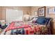 Cozy bedroom with a patterned quilt, vintage accents, and neutral walls at 9442 N 106Th Pl, Scottsdale, AZ 85258