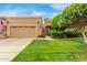 Charming single-story home with a well-manicured lawn and a two-car garage, with lovely trees at 9442 N 106Th Pl, Scottsdale, AZ 85258