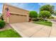 View of the home's front exterior with a spacious driveway and well-maintained landscaping and garage at 9442 N 106Th Pl, Scottsdale, AZ 85258