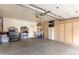 Spacious garage with cabinetry, overhead lighting, and an automatic garage door at 9442 N 106Th Pl, Scottsdale, AZ 85258