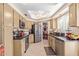 Kitchen featuring tile flooring, stainless appliances, beige cabinetry, and adjoining breakfast nook at 9442 N 106Th Pl, Scottsdale, AZ 85258