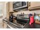 Modern kitchen range with stainless steel appliances and a sleek black countertop at 9442 N 106Th Pl, Scottsdale, AZ 85258