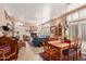 Bright living area with a fireplace, comfortable furniture, and an adjacent dining area at 9442 N 106Th Pl, Scottsdale, AZ 85258