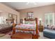 Cozy main bedroom with a comfortable bed, rustic furniture, and ample natural light at 9442 N 106Th Pl, Scottsdale, AZ 85258