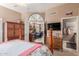 Light-filled bedroom features a comfortable bed, wooden furniture, and neutral decor at 9442 N 106Th Pl, Scottsdale, AZ 85258