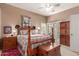 Spacious main bedroom with a patterned bedspread, chest, and bright natural light at 9442 N 106Th Pl, Scottsdale, AZ 85258