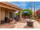 Backyard patio with terracotta tile, with cozy outdoor seating and lush landscaping at 9442 N 106Th Pl, Scottsdale, AZ 85258
