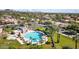 A serene aerial view showcases a large community pool with pristine blue water, lush landscaping, and mountain views at 9442 N 106Th Pl, Scottsdale, AZ 85258