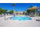 An inviting in-ground spa features clear blue water, stylish patio furniture, and secure fencing, perfect for relaxation at 9442 N 106Th Pl, Scottsdale, AZ 85258