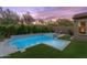 Backyard oasis showcasing a modern pool, spa, and well-manicured landscaping perfect for evening relaxation at 10778 N 137Th St, Scottsdale, AZ 85259