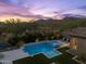 Serene backyard featuring a luxurious pool, spa, and elegant patio furniture, set against a backdrop of lush greenery at 10778 N 137Th St, Scottsdale, AZ 85259