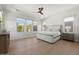 A primary bedroom featuring bright natural light, a ceiling fan, and light hardwood flooring at 10778 N 137Th St, Scottsdale, AZ 85259
