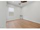 Open bedroom with hardwood floors and window and ceiling fan at 10778 N 137Th St, Scottsdale, AZ 85259