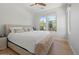 Bright bedroom featuring a large bed with soft bedding, hardwood floors, and natural light from a window at 10778 N 137Th St, Scottsdale, AZ 85259