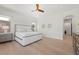 Bright bedroom with a ceiling fan, light hardwood flooring, and ensuite bath at 10778 N 137Th St, Scottsdale, AZ 85259