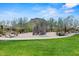 Community playground featuring a climbing wall and lush green grass surrounded by trees at 10778 N 137Th St, Scottsdale, AZ 85259