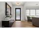 Elegant foyer with chandelier, wood floors, console table, and glass front door providing natural light at 10778 N 137Th St, Scottsdale, AZ 85259