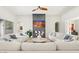 Bright living room with fireplace, ceiling fan, and white sofas in a modern home at 10778 N 137Th St, Scottsdale, AZ 85259