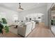 Light-filled living room with hardwood floors, ceiling fan, and backyard access with kitchen view at 10778 N 137Th St, Scottsdale, AZ 85259