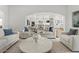 Open-concept living space with elegant decor and modern lighting and direct view to kitchen at 10778 N 137Th St, Scottsdale, AZ 85259