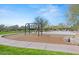 Community playground with swings, basketball court, and benches surrounded by green space at 10778 N 137Th St, Scottsdale, AZ 85259