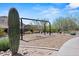 Community playground with a swing set, native plants, and desert landscaping for outdoor play at 10778 N 137Th St, Scottsdale, AZ 85259