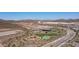 Aerial view of new construction neighborhood with pool, park, and desert landscape at 13511 W Cassia Trl, Peoria, AZ 85383