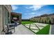 Large extended backyard patio with artificial grass and shade at 13511 W Cassia Trl, Peoria, AZ 85383