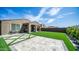 This backyard features an extended patio and lush artificial turf at 13511 W Cassia Trl, Peoria, AZ 85383