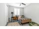 Stylish bedroom with modern furnishings, neutral walls, and a checkered blanket at 13511 W Cassia Trl, Peoria, AZ 85383