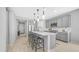 Modern kitchen with gray cabinets, stainless steel appliances, a spacious island with seating, and elegant pendant lighting at 13511 W Cassia Trl, Peoria, AZ 85383