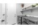 Modern laundry room with gray washer and dryer and storage shelving above at 13511 W Cassia Trl, Peoria, AZ 85383