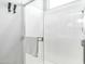 Enclosed glass shower with bright white tile and chrome hardware at 13511 W Cassia Trl, Peoria, AZ 85383
