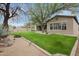 Beautiful backyard with lush lawn, mature trees, and well-manicured landscaping at 1608 W Calle De Pompas --, Phoenix, AZ 85085