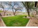 Large backyard featuring well-maintained landscaping and gravel areas at 1608 W Calle De Pompas --, Phoenix, AZ 85085