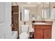A well-maintained bathroom with tile accents, a vanity, and a shower-tub combination at 1608 W Calle De Pompas --, Phoenix, AZ 85085