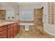 Bright bathroom showcasing a tub with tiled surround, and double vanity at 1608 W Calle De Pompas --, Phoenix, AZ 85085